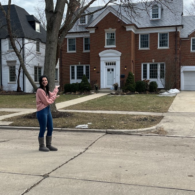 Girl Standing in Front of Sixteen Candles Home