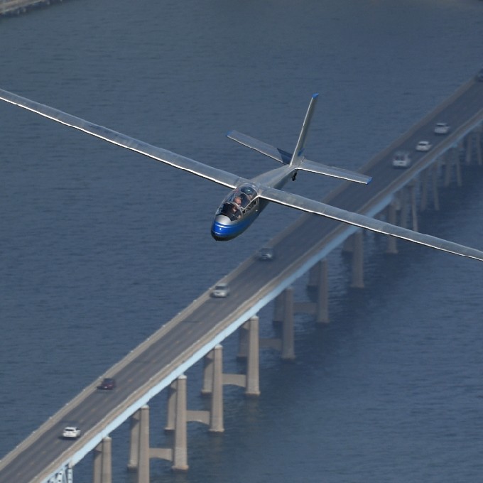 Glider Plane Flying Over Water