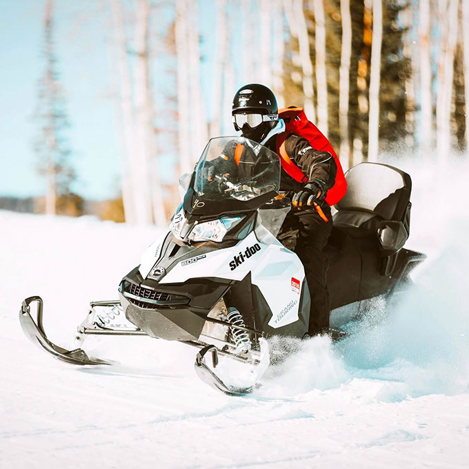 Person Driving Snowmobile
