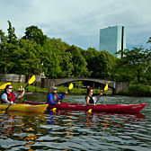 People Kayaking on a Tour around Boston