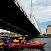 Kayaking under a bridge in Boston