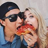 Couple eating deep dish pizza