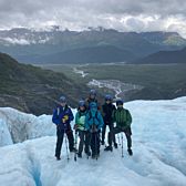 Group Posing on Glacier with Mountain View