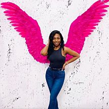 Girl Posing in Front of Pink Wings
