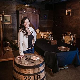 Girl in Escape Room Touching Barrell 