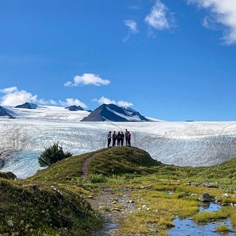 Group in the Distance Looking at Ice Mountains