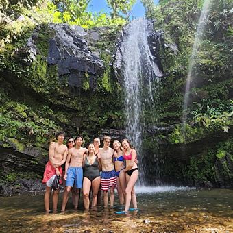 Group Posing in Front of Waterfall