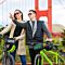 Couple on Bikes in Front of Golden Gate Bridge