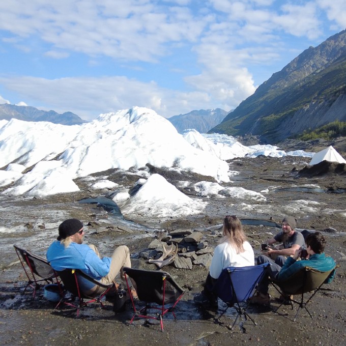 People in Front of Campfire on Glacier