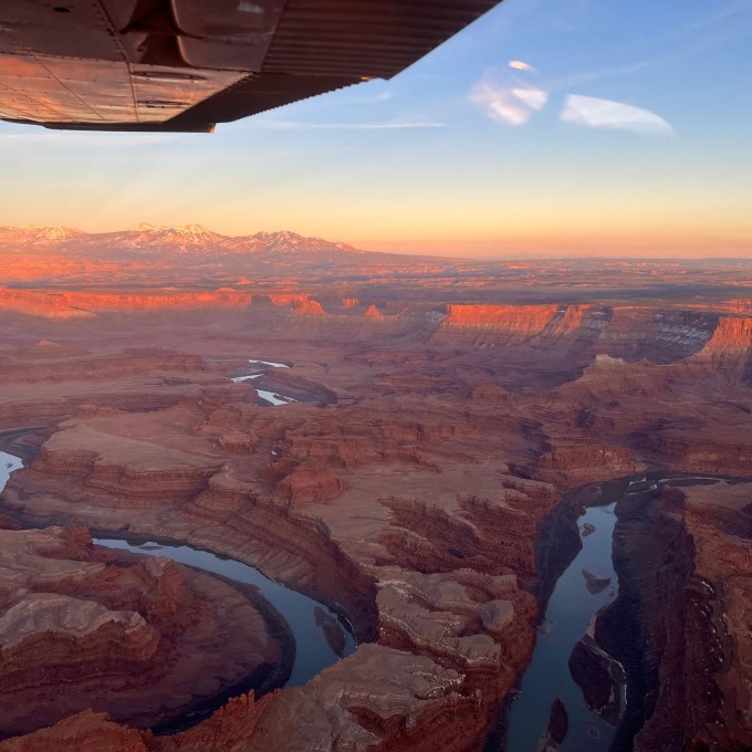 Plane Over Lakes and Canyon at Sunset